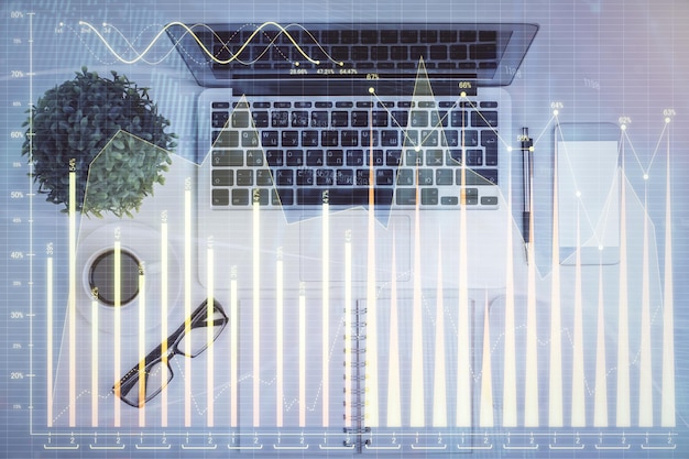 multi exposure of forex chart drawing over table background with computer concept of financial research and analysis top view