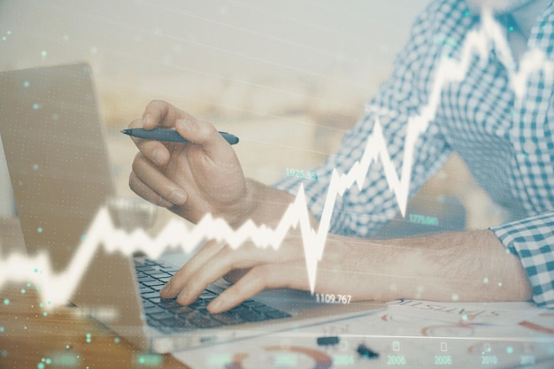 Multi exposure of forex graph with man working on computer on background Concept of market analysis