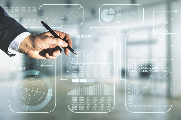 Multi exposure of male hand with pen working with abstract virtual graphic data spreadsheet sketch on blurred office background analytics and analysis concept