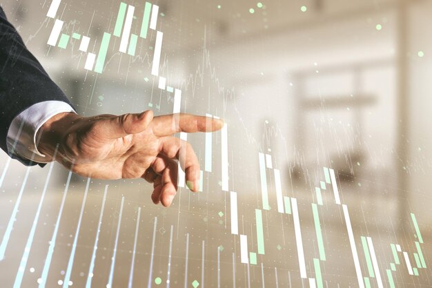 Photo multi exposure of man hand with pen working with abstract virtual financial graph on blurred office background forex and investment concept