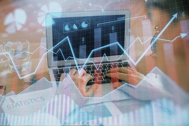Multi exposure of market chart with man working on computer on background Concept of financial analysis