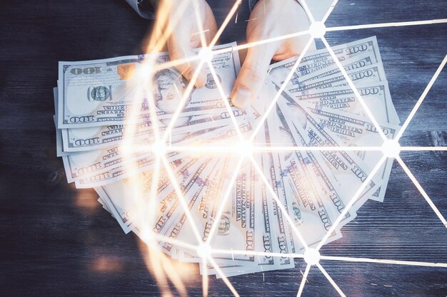 Multi exposure of social network theme drawing hologram and USA dollars bills and man hands