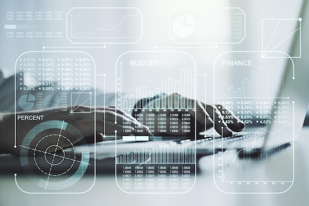 Multi exposure of stats data illustration with hands typing on computer keyboard on background computing and analytics concept