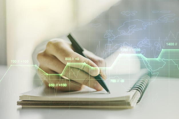 Multi exposure of stats data illustration with man hand writing in notebook on background computing and analytics concept