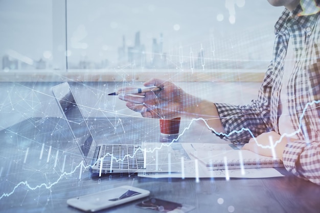 Multi exposure of stock market chart with man working on computer on background Concept of financial analysis