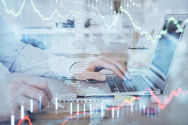 Multi exposure of stock market chart with man working on computer on background Concept of financial analysis