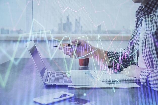 Multi exposure of stock market chart with man working on computer on background Concept of financial analysis