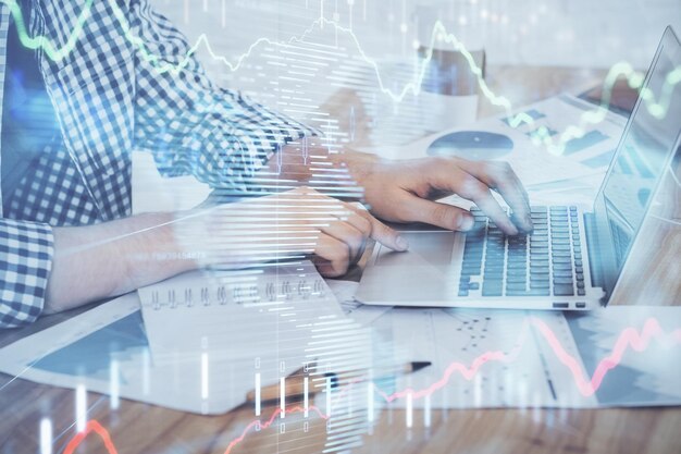 Multi exposure of stock market chart with man working on computer on background Concept of financial analysis