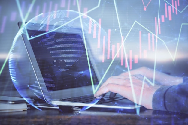 Multi exposure of stock market graph with man working on laptop on background Concept of financial analysis