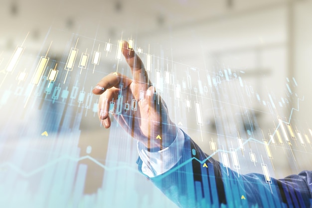 Multi exposure of trader hand clicks on virtual abstract financial graph interface on blurred office background financial and trading concept