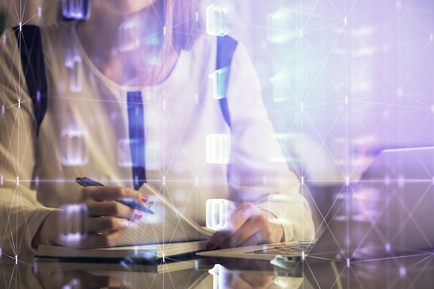 Multi exposure of woman hands working on computer and data theme hologram drawing Tech concept