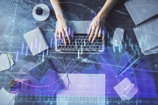 Multi exposure of woman hands working on computer and forex chart hologram drawing Top View Financial analysis concept