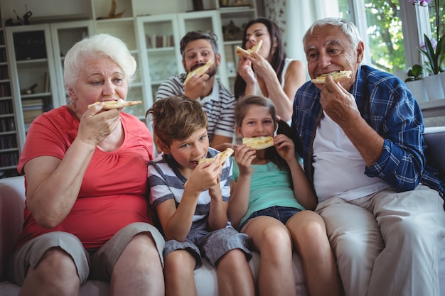 Multi-generation family having pizza together