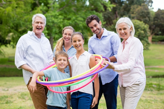 Multi-generation family playing with hula hoop