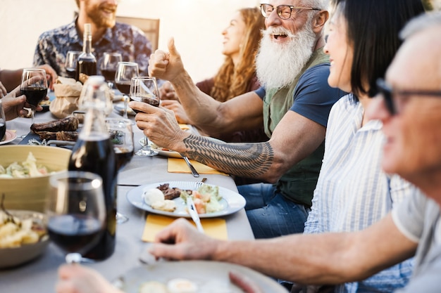 Multi generational people having fun at barbecue patio dinner 