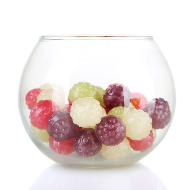 Multicolor candies in glass bowl isolated on white