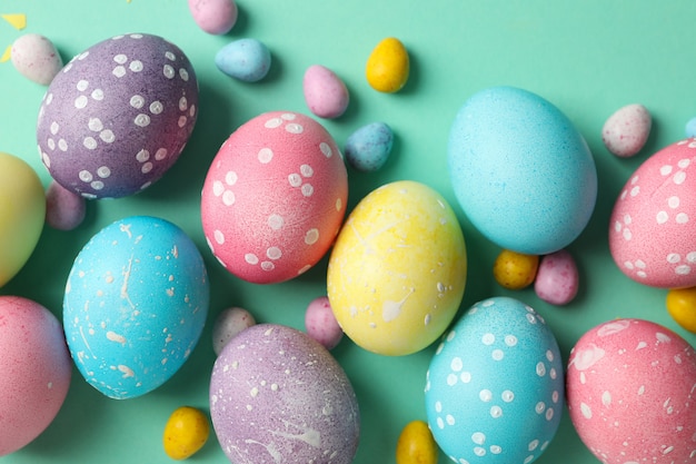 Multicolor Easter eggs on mint surface