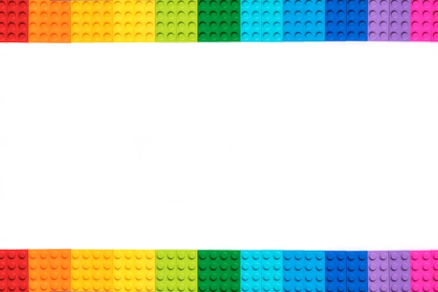 Multicolor Plastick constructor bricks on white background. Popular toys. Copyspace