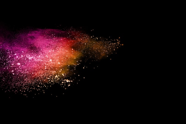 Multicolor powder explosion on black background.  