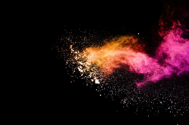 Multicolor powder explosion on black background.  