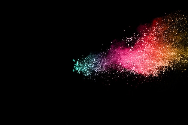 Multicolor powder explosion on black background.  