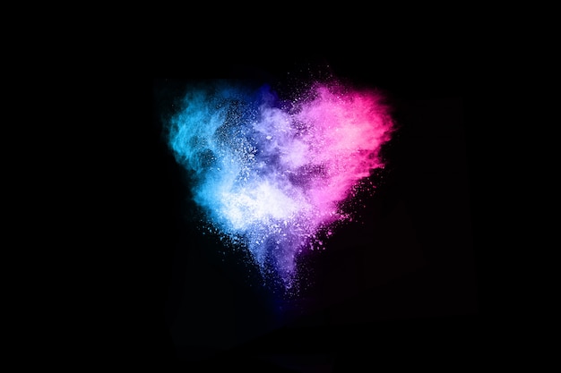 Multicolor powder explosion on black background.  