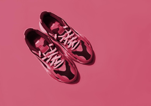 Multicolor sport shoes on background. New 2023 trending PANTONE 18-1750 Viva Magenta colour