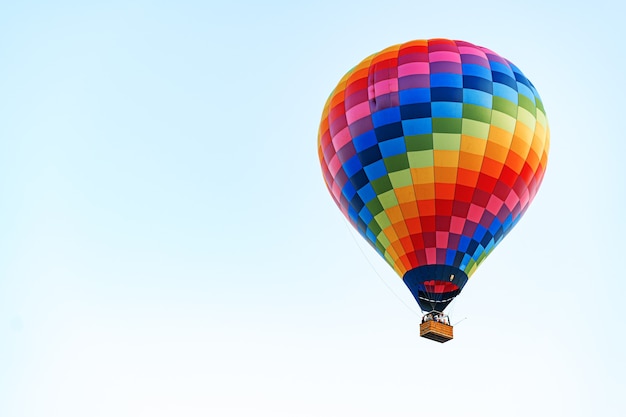 Multicolored air balloon in clear blue sky