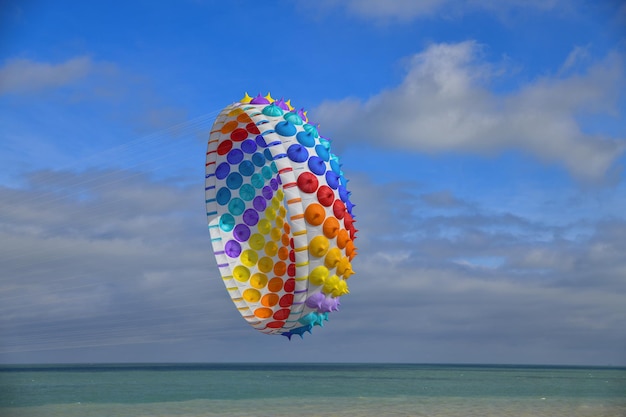 Multicolored air kite in the sky in Atlantic ocean