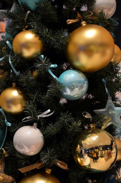 Multicolored beautiful christmas balls decorations on christmas tree close up