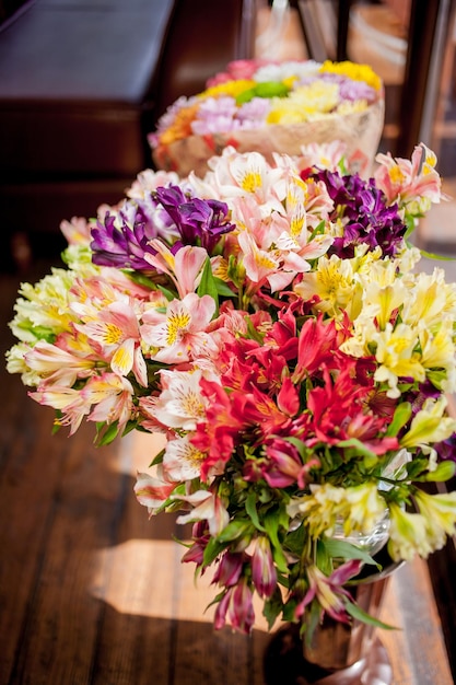 multicolored bouquet of colorful different flowers on blurred background