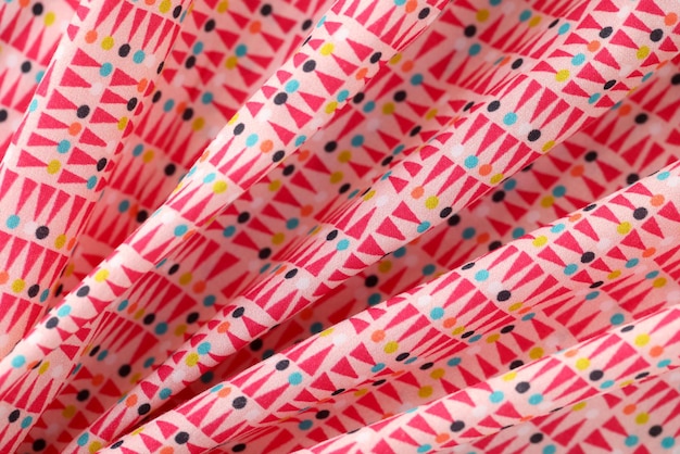 Multicolored bright cotton fabric with geometric shapes texture background concept