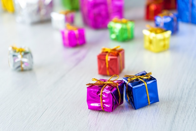 Multicolored bright holiday gift boxes of various sizes on a white.