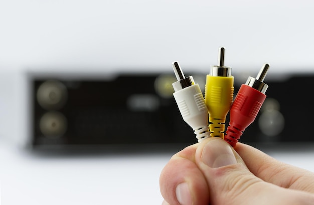 Multicolored cable plugs in hand