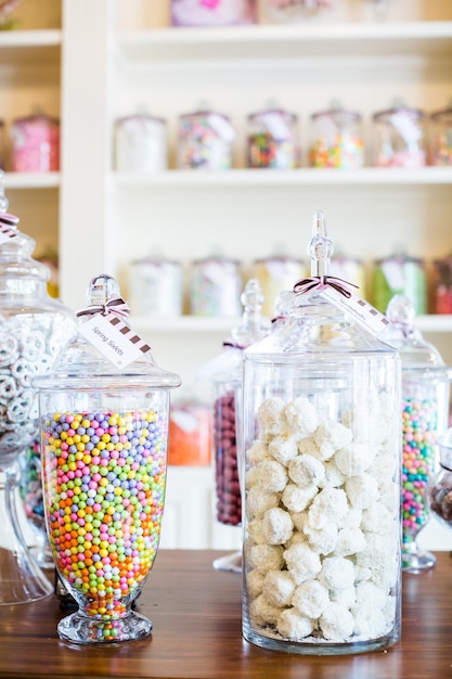 Photo multicolored candies on display at the candy store.