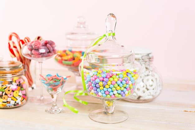 Multicolored candies in glass candy jars.