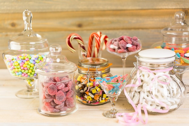 Multicolored candies in glass candy jars.