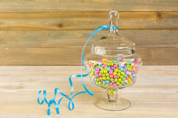 Photo multicolored candies in glass candy jars.