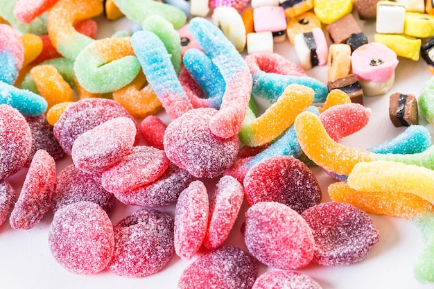 Multicolored candies on a white table.