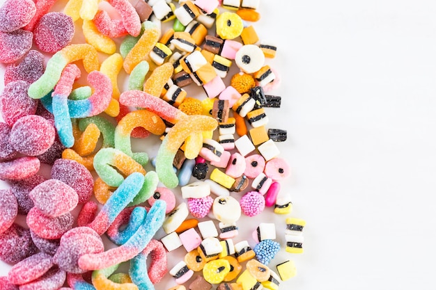 Multicolored candies on a white table.