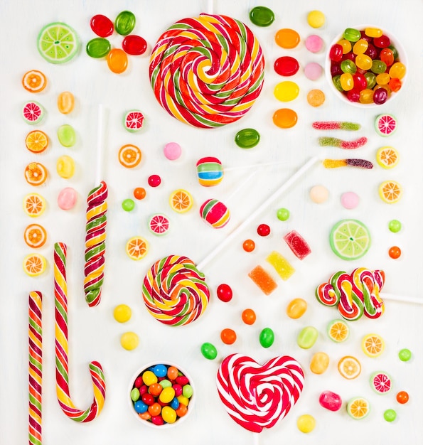 Multicolored candy on light painted background Top view Flat lay