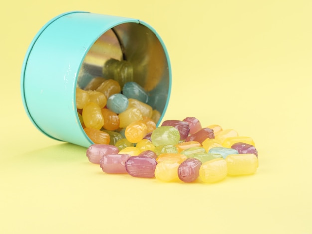 Multicolored caramel candies in a blue tin can.