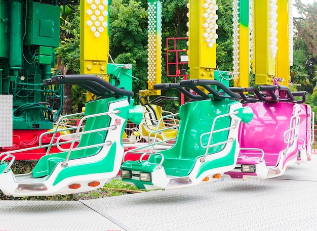 Multicolored chairs on an attraction in an amusement park