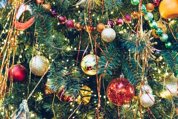 Multicolored christmas balls on a christmas tree closeup