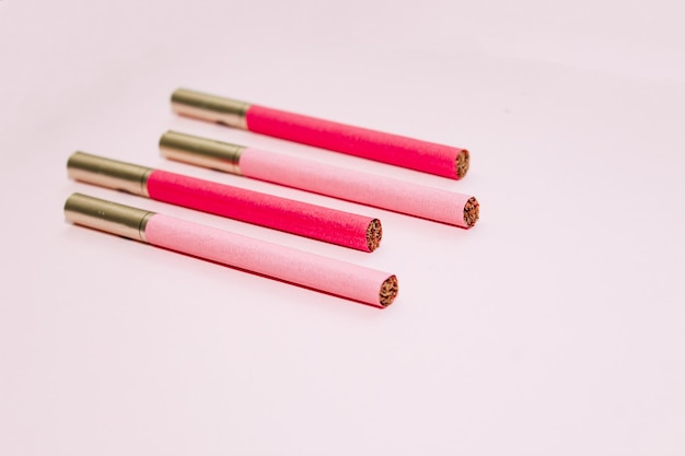 Multicolored cigarettes on a paper background the concept of a bad habit