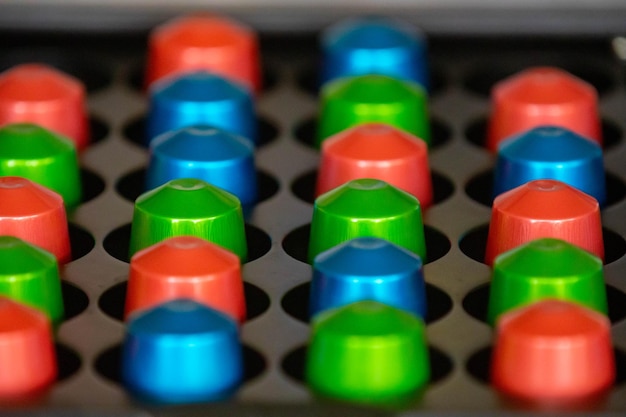 Multicolored coffee capsules for coffee maker in selective focus and depth of field blur