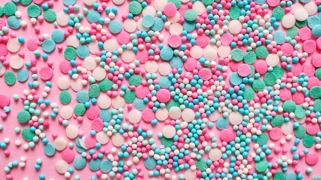 Multicolored confectionery topping on a pink