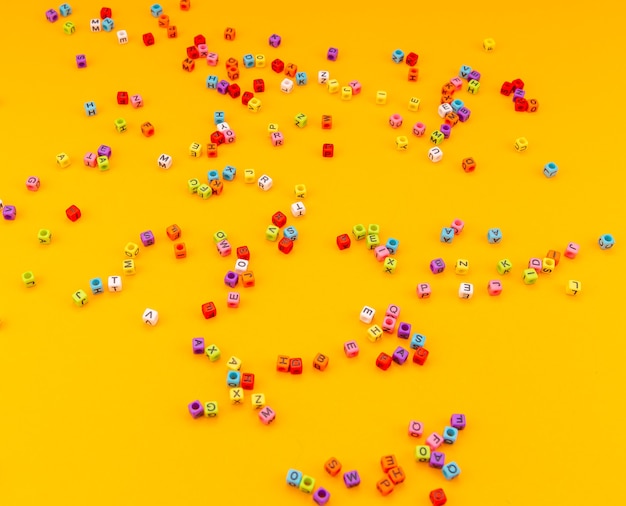 multicolored cubes with letters on a yellow background