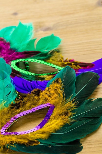 Multicolored decorations for Mardi Gras party on the table.