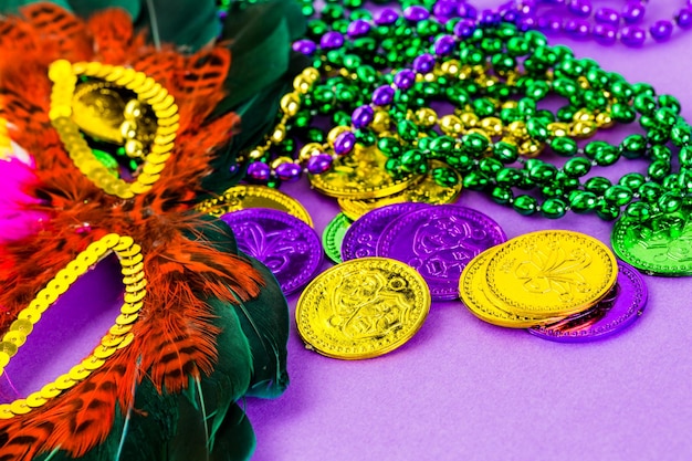 Multicolored decorations for Mardi Gras party on the table.